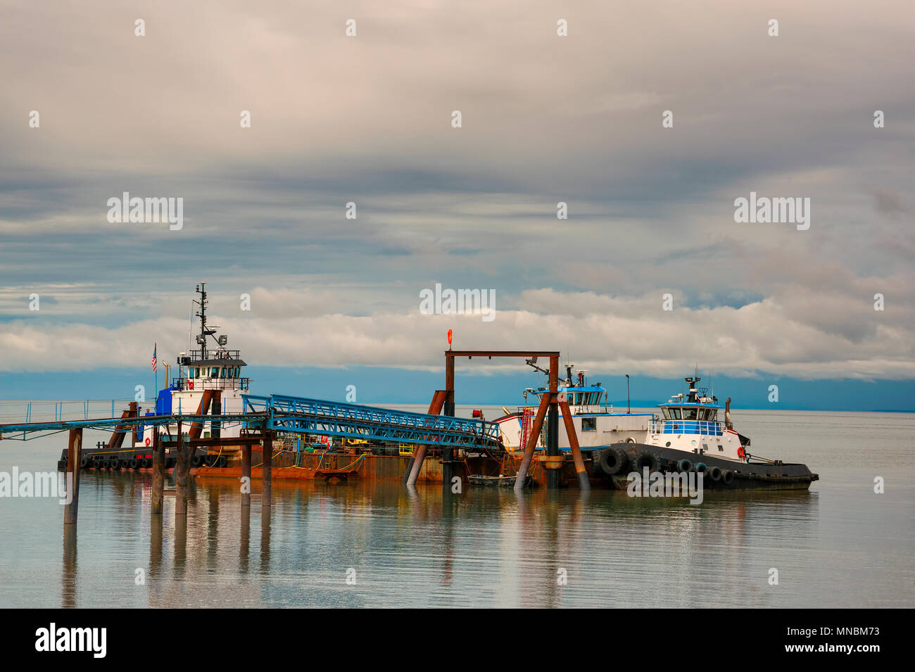 Boats docked to pier in Cook's Inlet in Anchorage, Alaska. Stock Photo