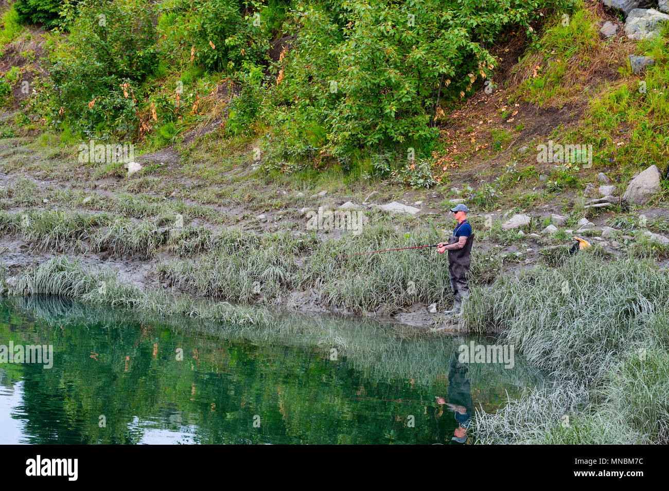 Fisherman standing on river bank hires stock photography and images