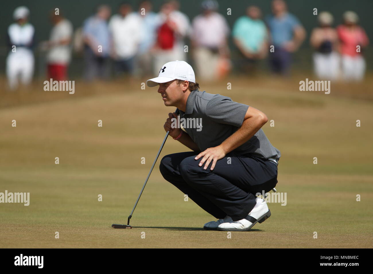 MUIRFIELD, SCOTLAND - JULY 20: Jordan Spieth studying his putt at the 1st green during the third round of The Open Championship 2013 at Muirfield Golf Club on July 20, 2013 in Scotland. Stock Photo