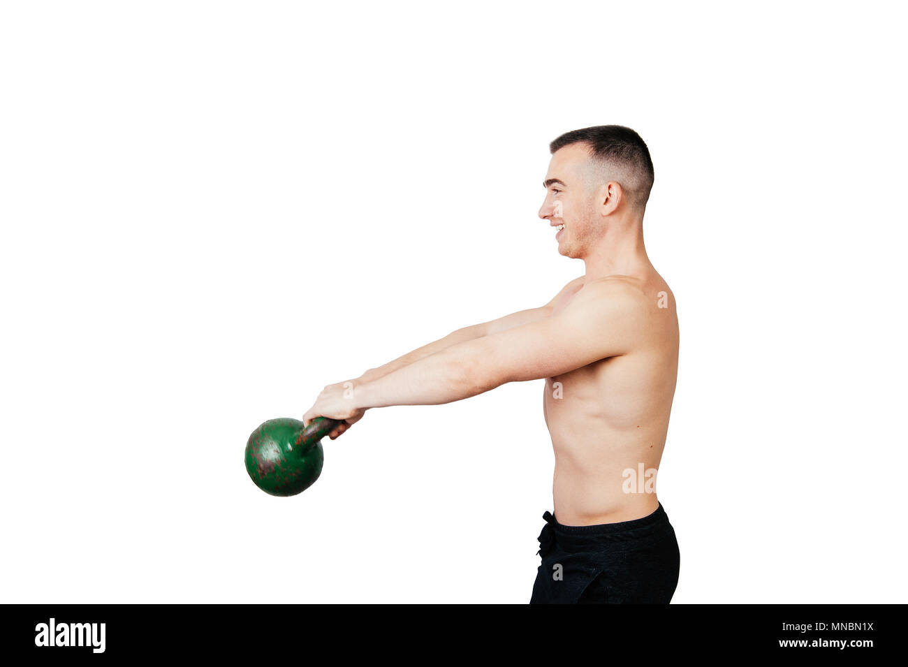 Strong young man swinging a kettlebell. Strength and motivation Stock Photo  - Alamy