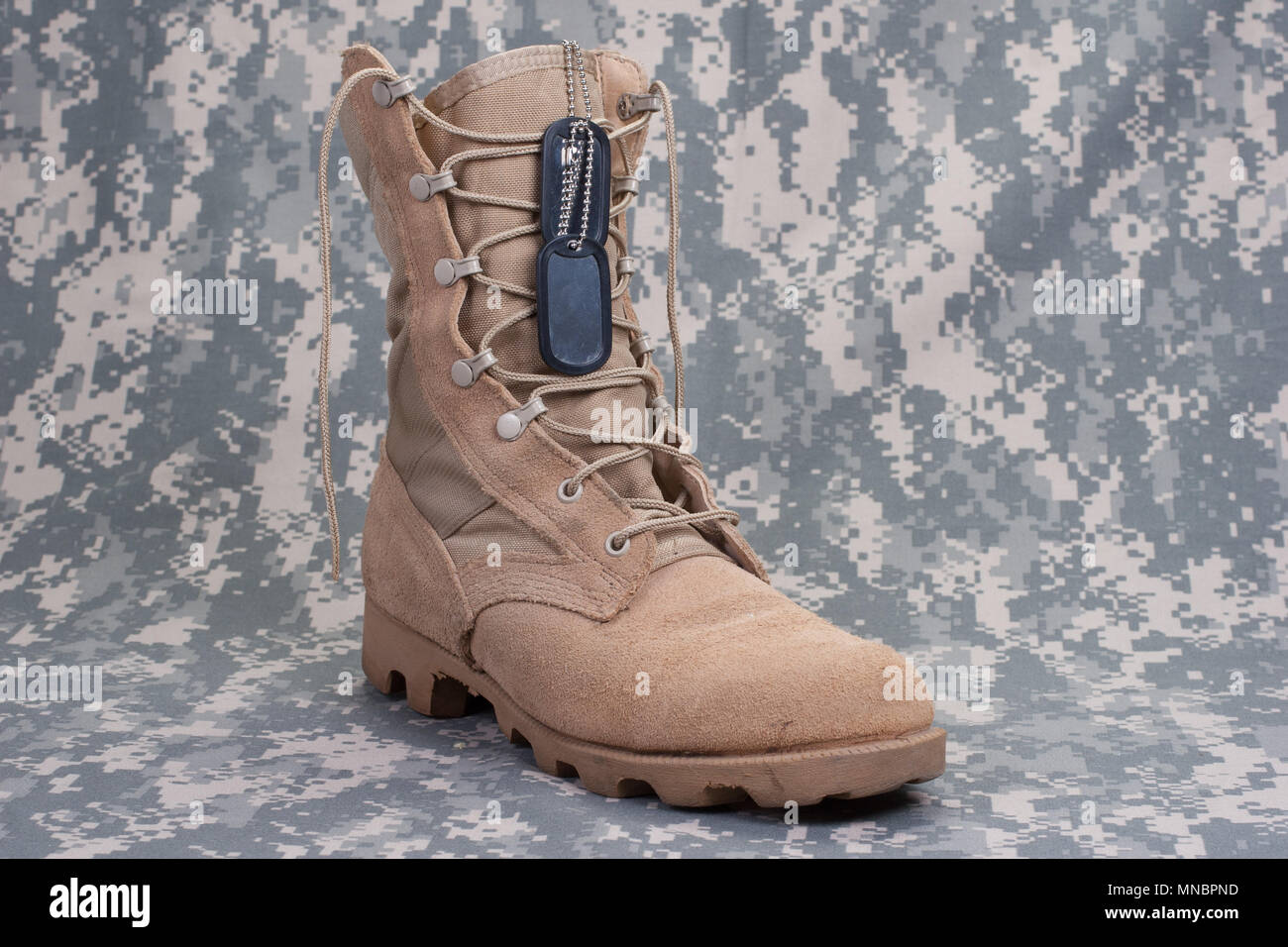 US ARMY concept - camouflage background with desert boots Stock Photo