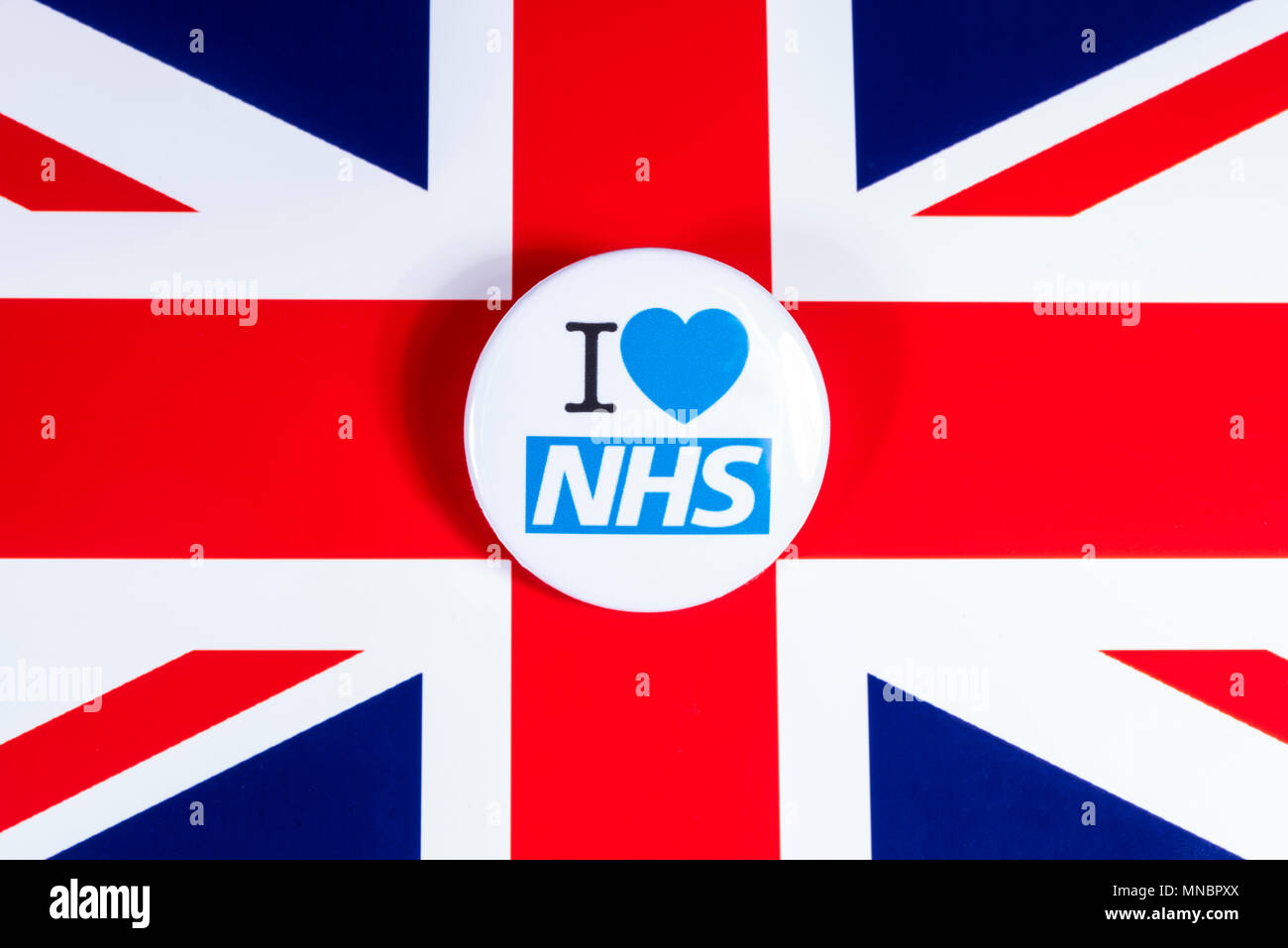 LONDON, UK - APRIL 27TH 2018: An I Love the NHS badge over the UK flag, on 27th April 2018.  The The National Health Service was established in 1948 a Stock Photo