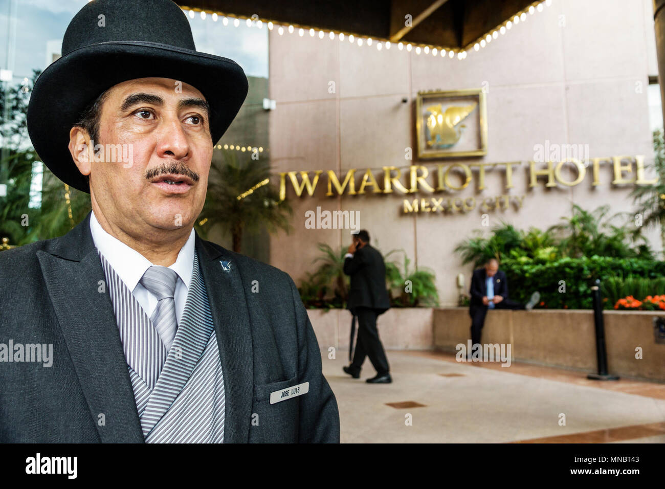 Mexico City,Polanco,Hispanic,immigrant immigrants,Mexican,JW Marriott,hotel,lobby entrance,doorman,porter,top hat,tails,moustache,bushy eyebrows,man m Stock Photo