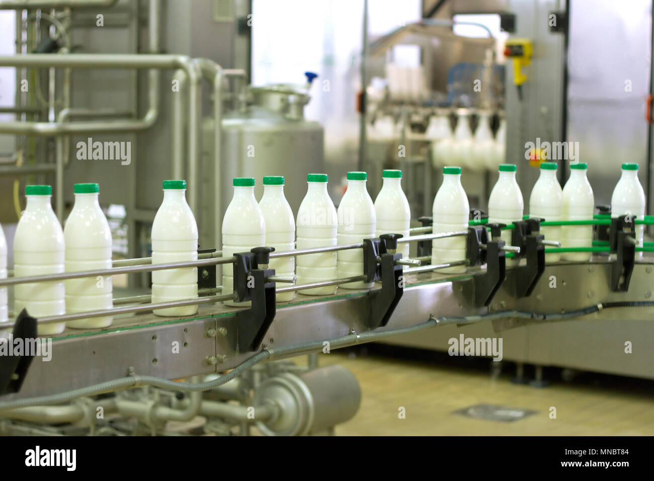 Dairy Plant. Conveyor with milk bottles Stock Photo - Alamy