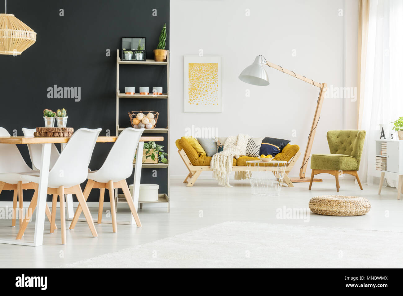 Black wall in modern dining room with wooden table Stock Photo