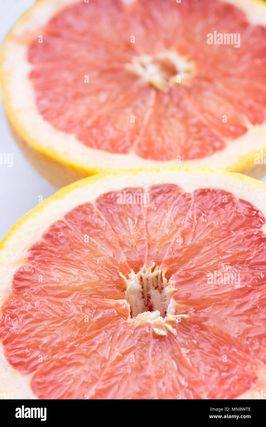 Semi Circle Slices of Ripe Juicy Red Halved Grapefruit on White Background. Vitamins Healthy Diet Summer Detox Vegan Superfoods Concept. Poster Banner Stock Photo