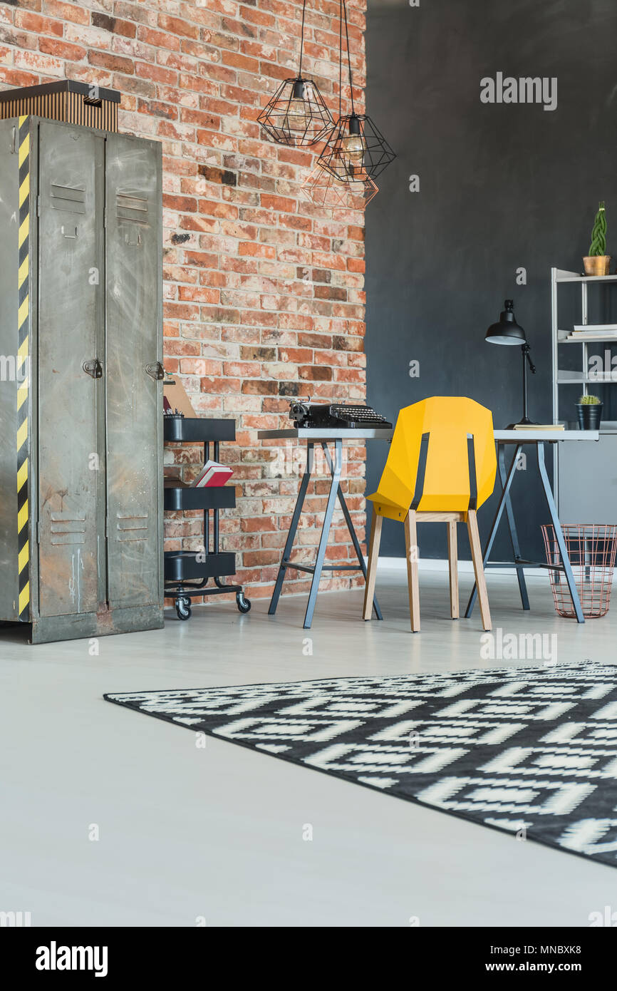 Industrial home office with brick wall and metal bookcase Stock Photo -  Alamy, image size:866x1390