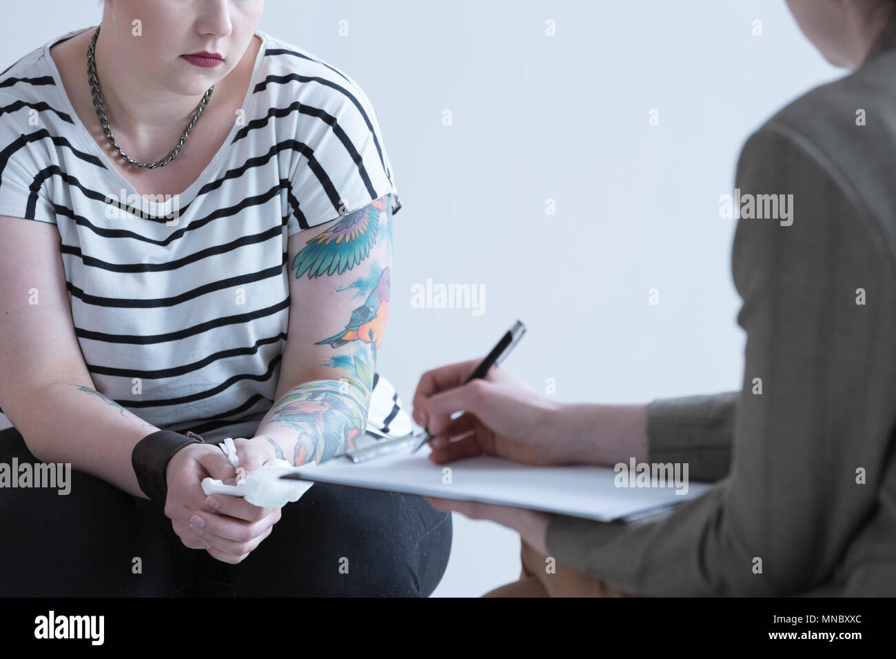 Rebellious girl with tattoo and school psychologist Stock Photo