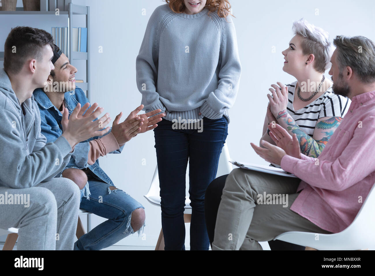Girl overcoming depression, talking in front of support group Stock Photo