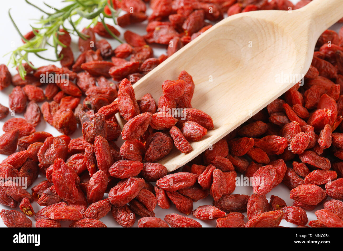 pile of healthy goji berries and woooden scoop - detail Stock Photo