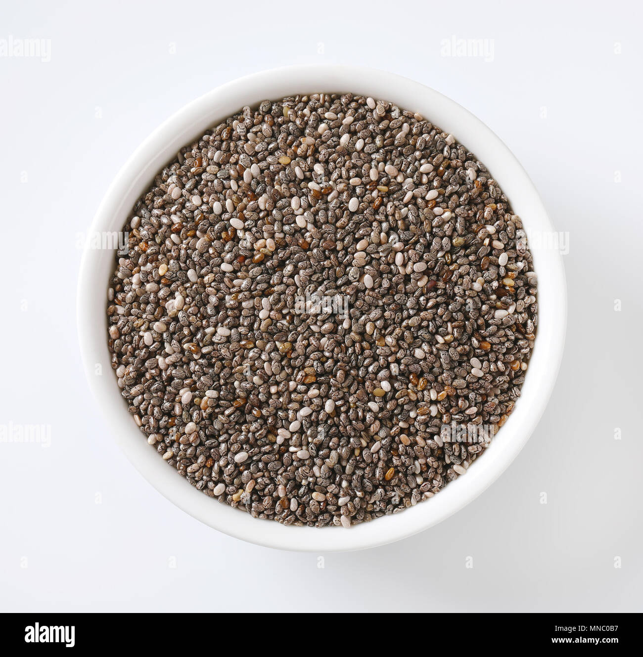 bowl of healthy chia seeds on white background Stock Photo