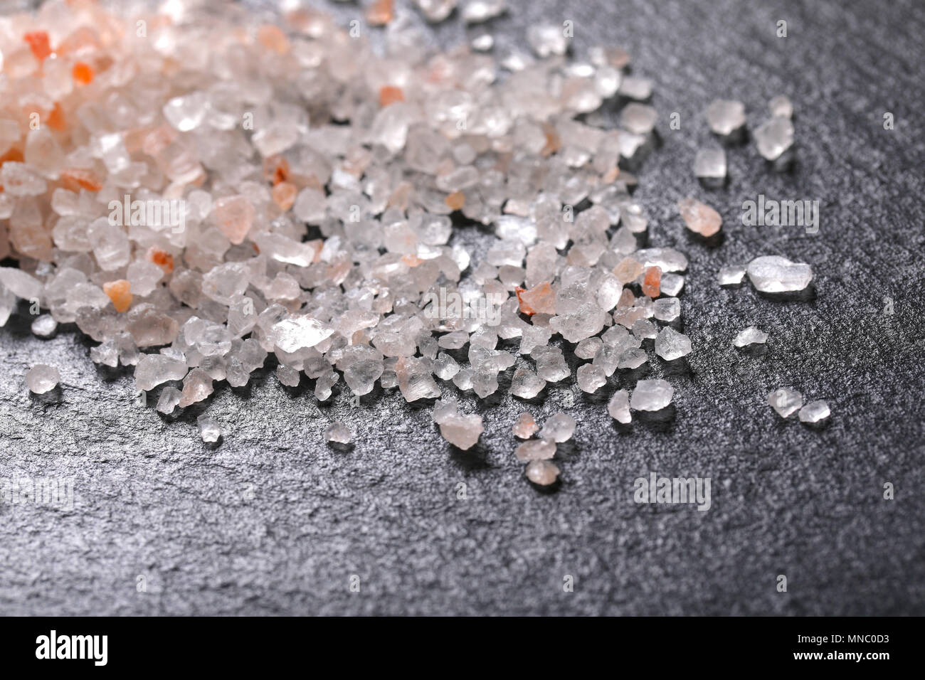 pile of coarse grained salt on black background - detail Stock Photo