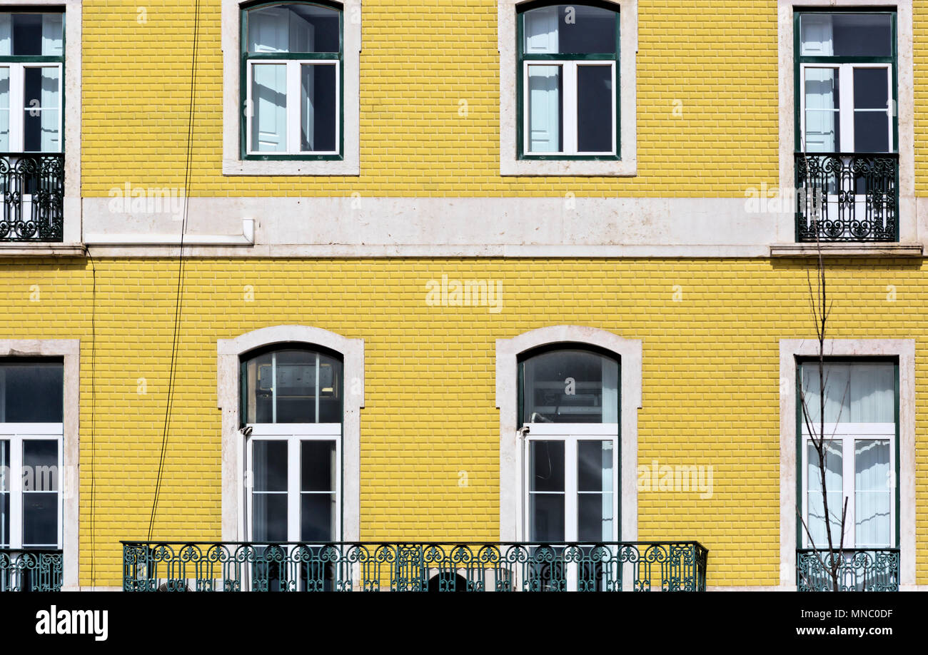 Detail of the facade of yellow house and windows, Lisbon Stock Photo