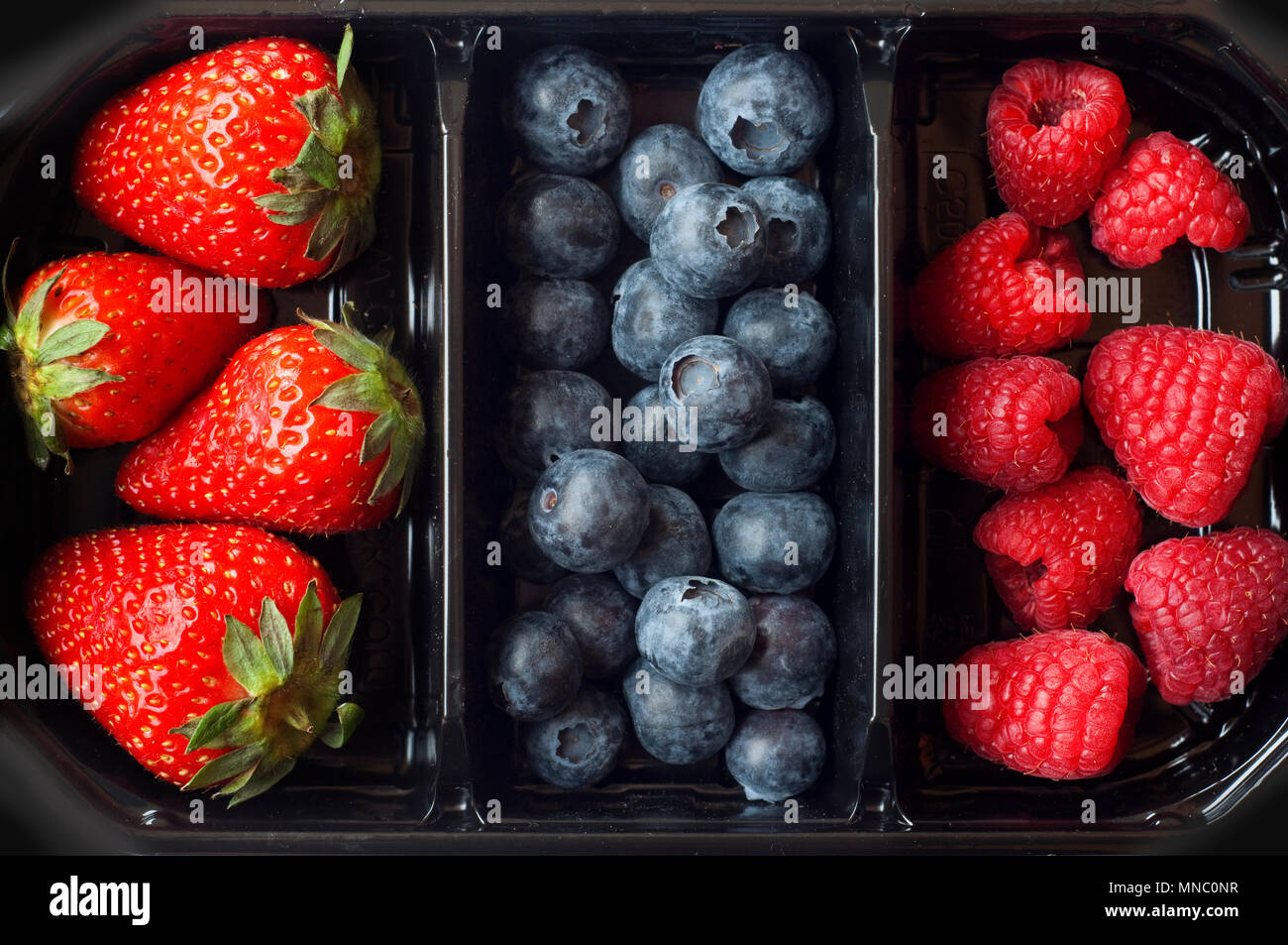 Plastic Tray With Raspberry Blueberries Strawberries Stock Photo