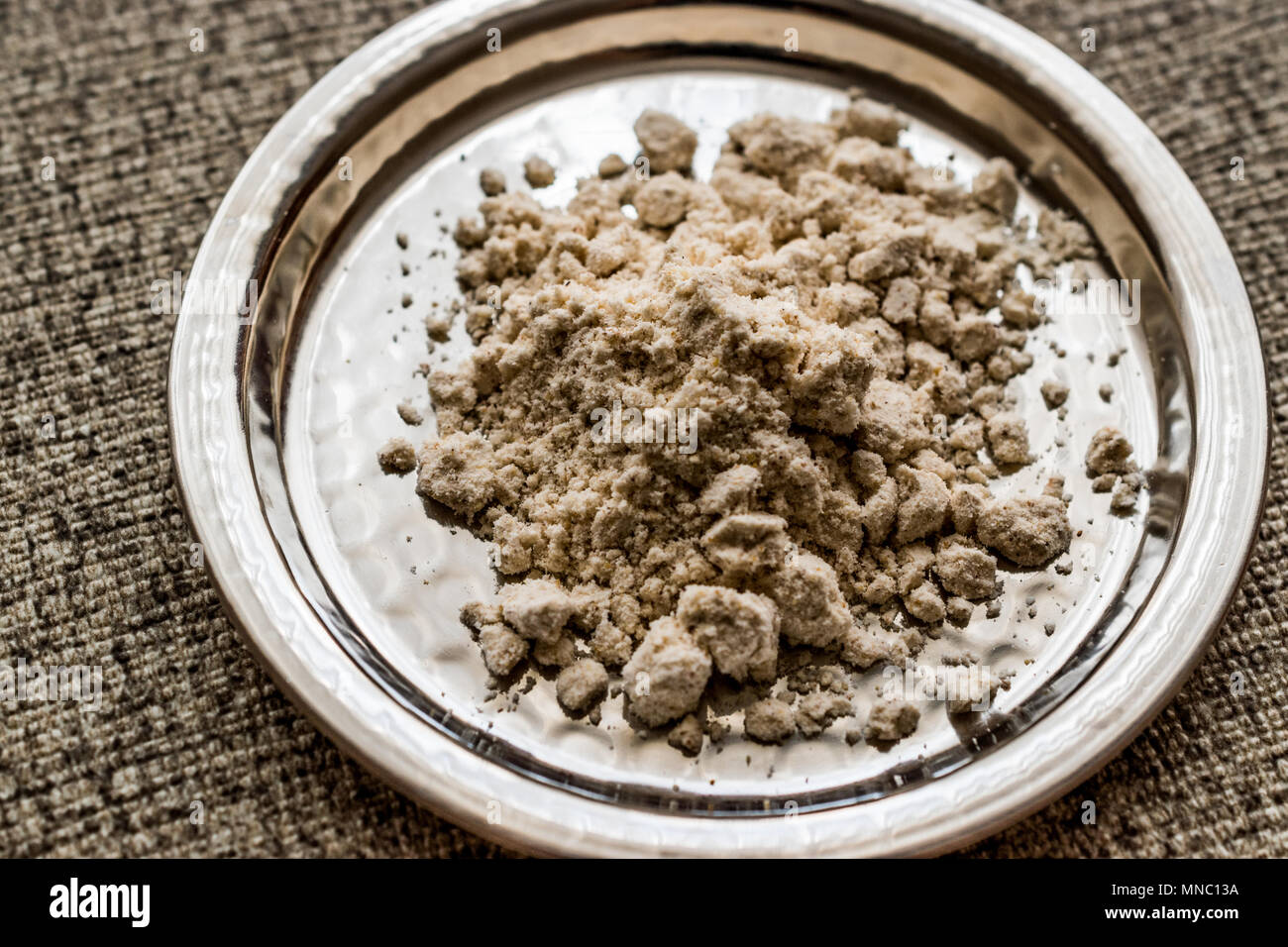 Mahlep, mahaleb or mahalep powder on silver plate. (Organic Concept.) Stock Photo