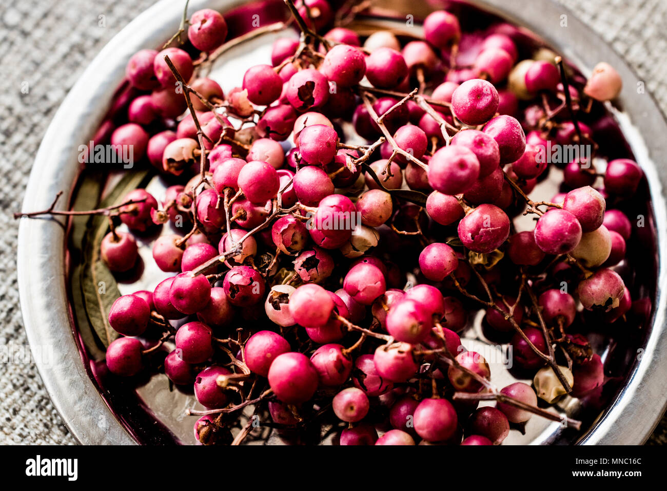 Organic Black Pepper Peas on silver plate (karabiber). Organic Concept. Stock Photo
