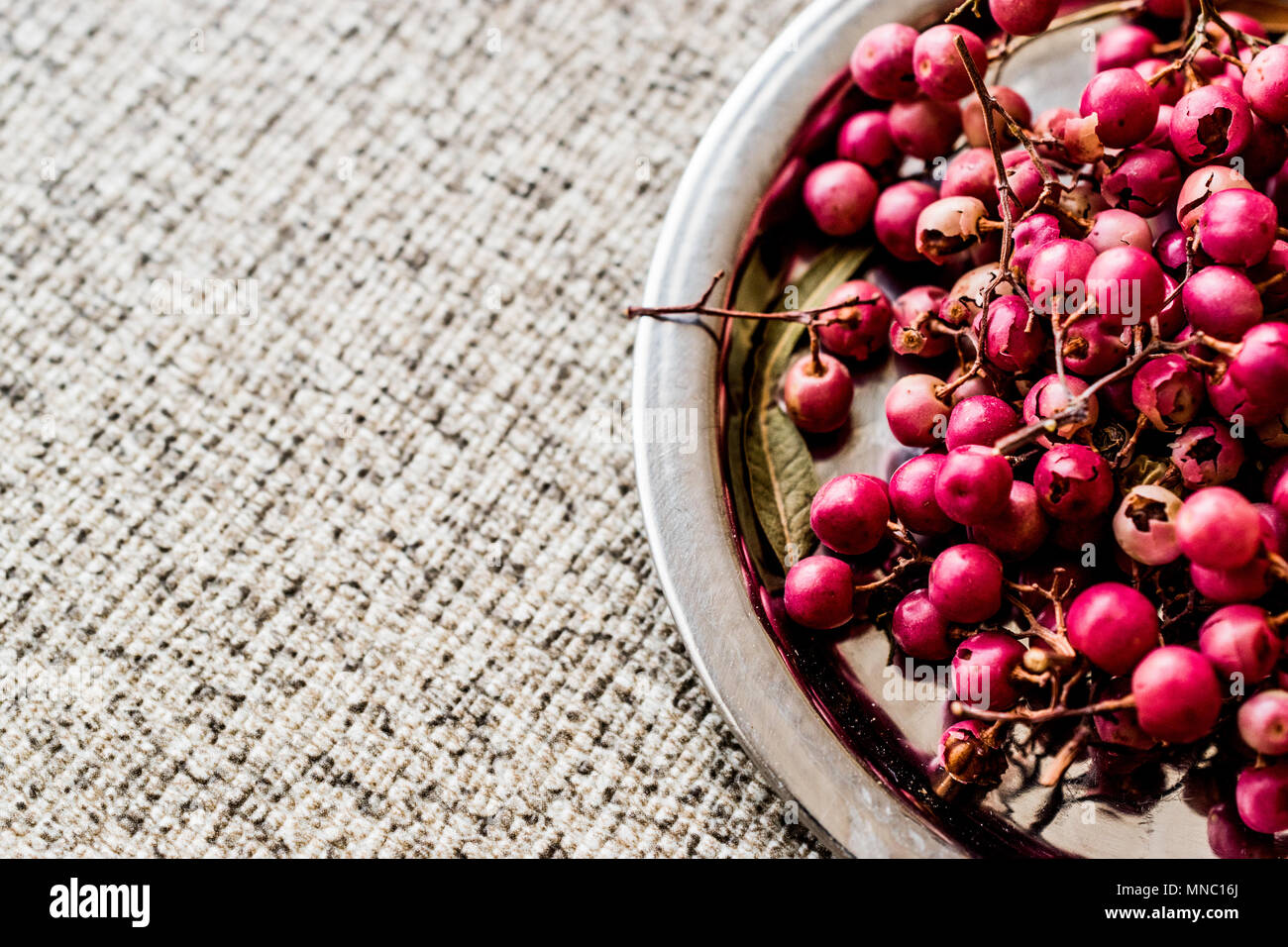 Organic Black Pepper Peas on silver plate (karabiber). Organic Concept. Stock Photo