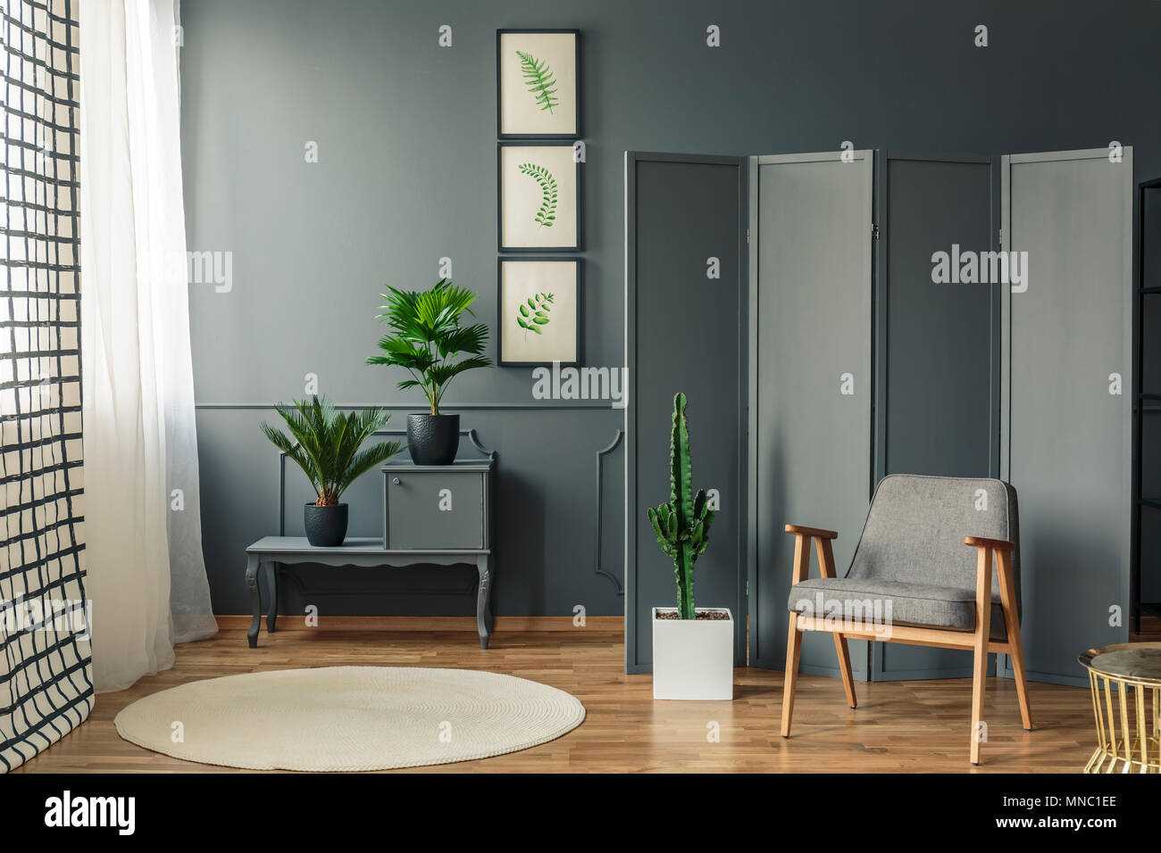 A Chair Standing In Front Of A Decorative Grey Screen Next