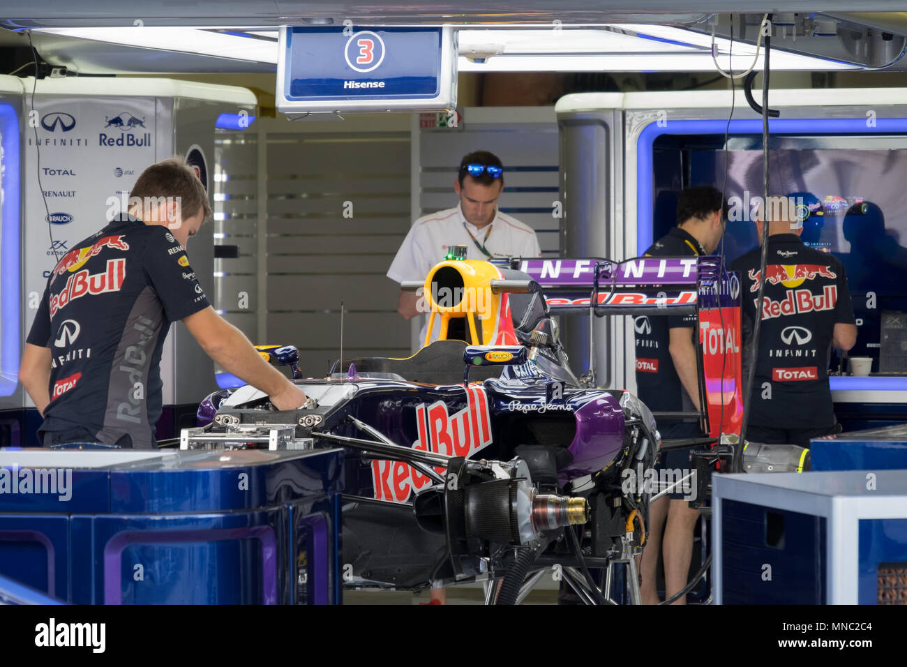 Mechanics preparing their car in the Red Bull garage prior to the Abu Dhabi grand prix. Stock Photo