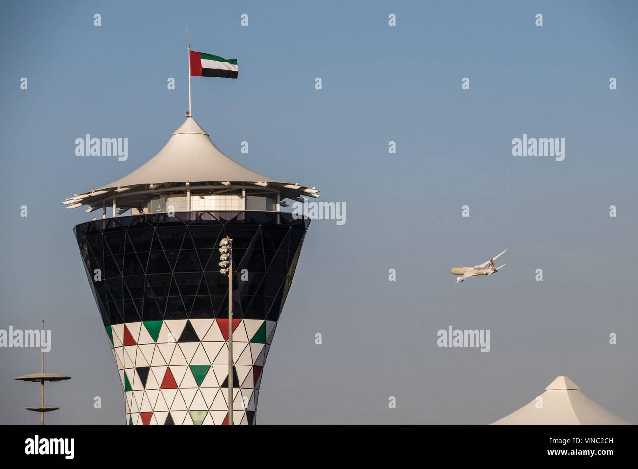 An Etihad plane flies over the Yas Marina grand prix circuit, Abu Dhabi Stock Photo