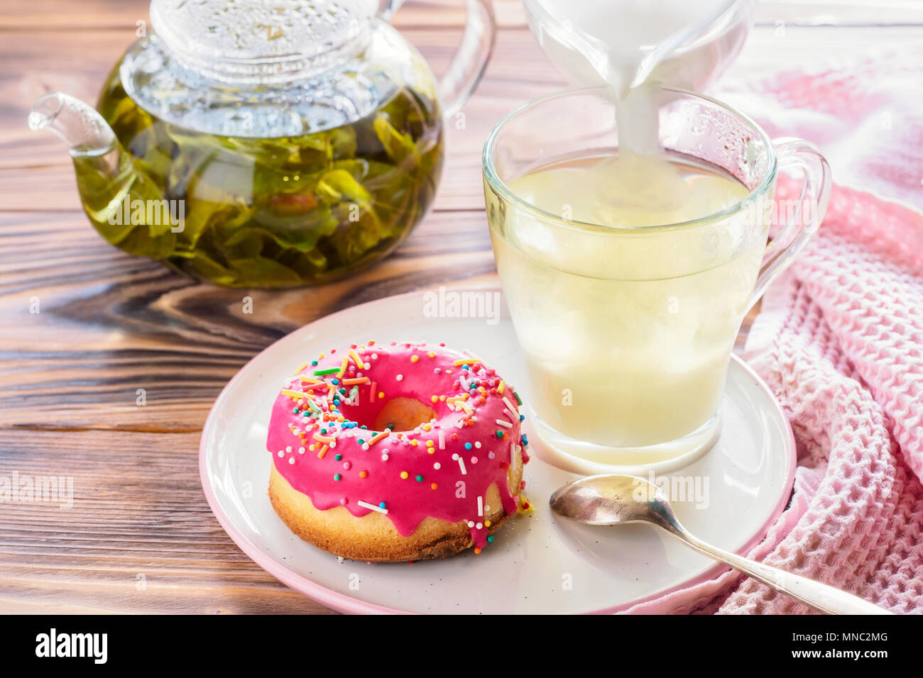 Cup of hot green tea beverages with donut glazed Stock Photo