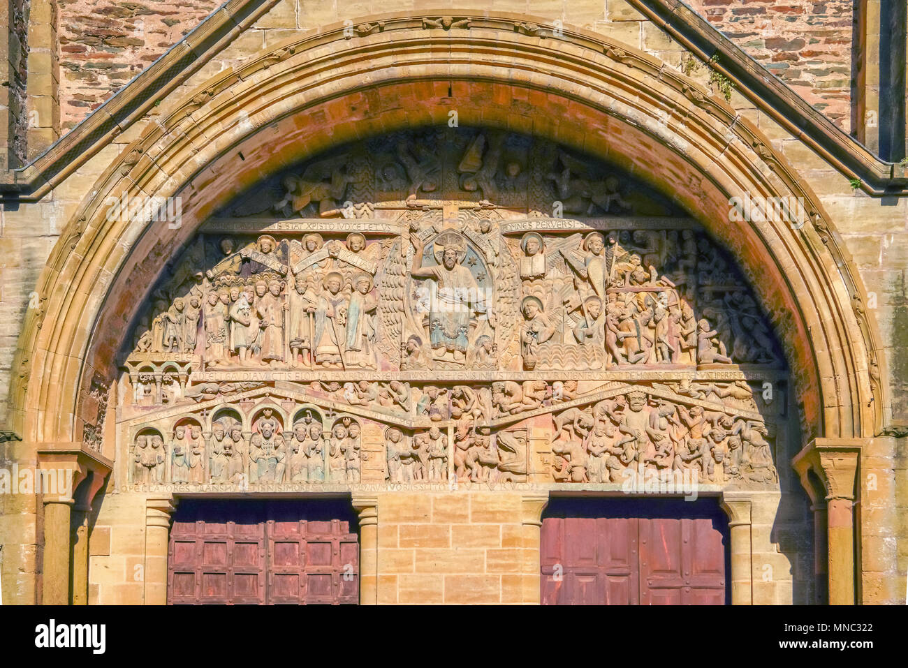 The Tympanum of Conques romanesque abbey Sainte-Foy, Occitanie, France. Stock Photo