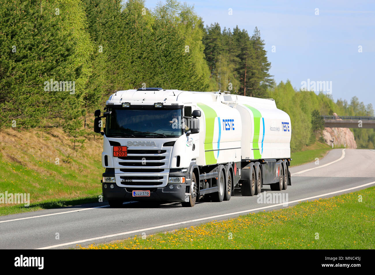 White Scania fuel tanker for Neste ADR transport of gasoline on freeway ramp on a beautiful day of early summer. Salo, Finland - May 12, 2018. Stock Photo