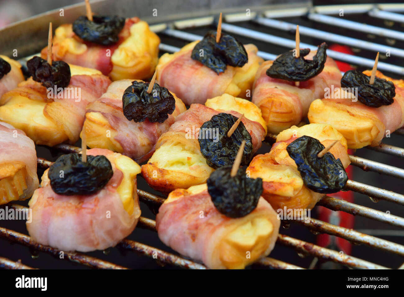 Smoked cheese grilled with pork meat, a delicacy. Krakow, Poland Stock Photo