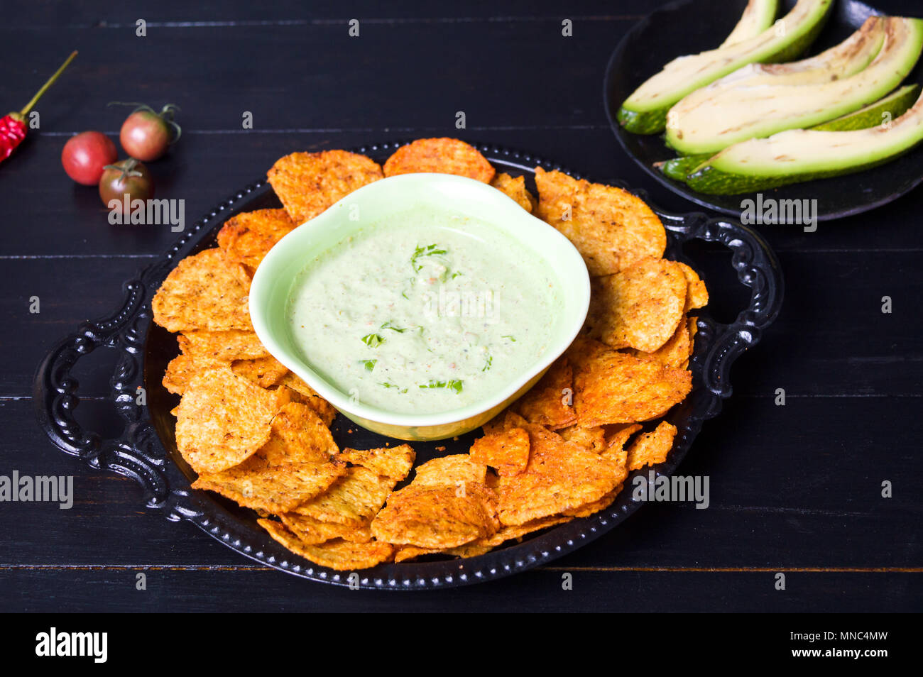Tortilla chips with avocado dip served on a plate Stock Photo Alamy