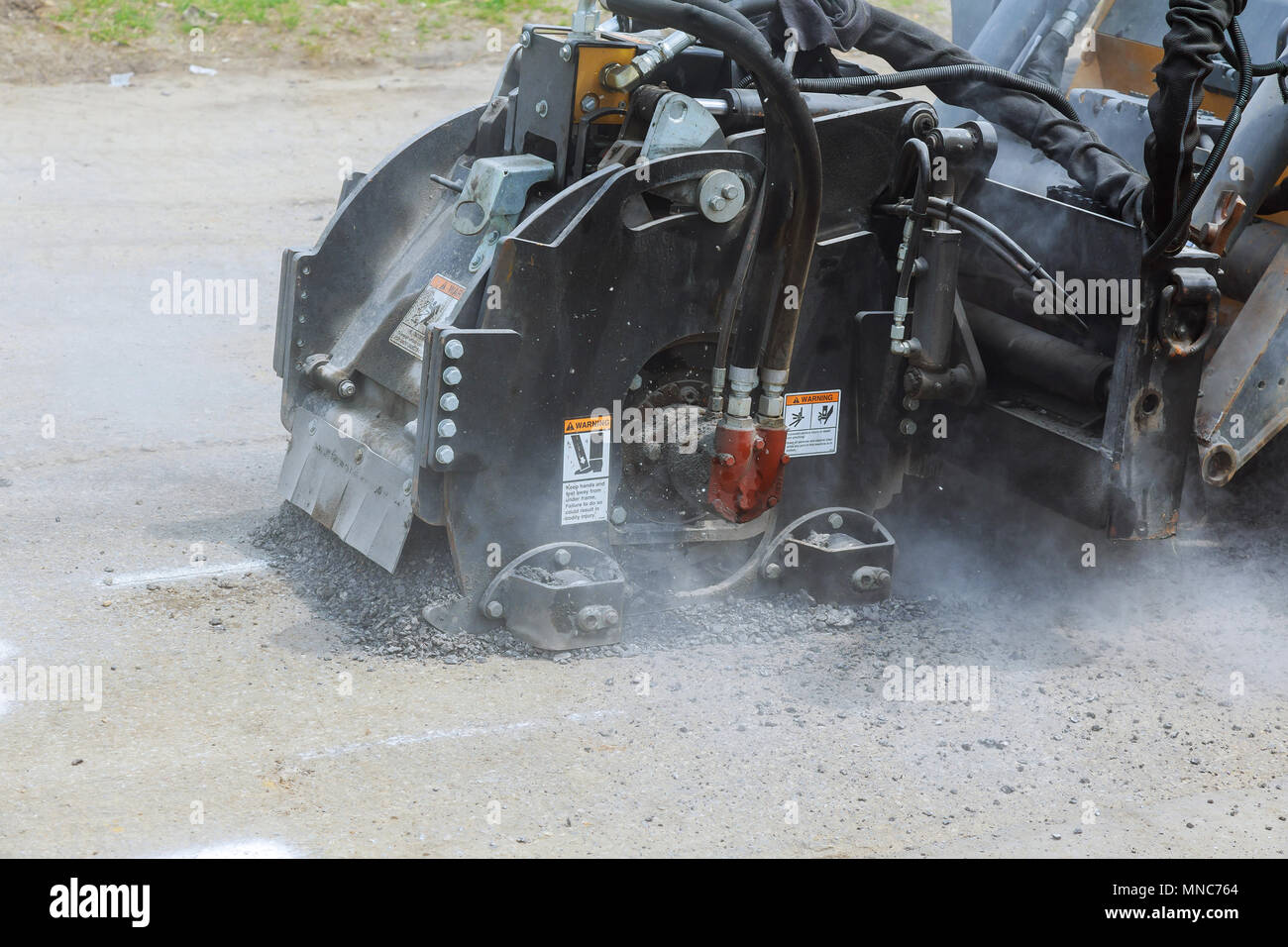 Worker checks the progress of the Milling of asphalt for road