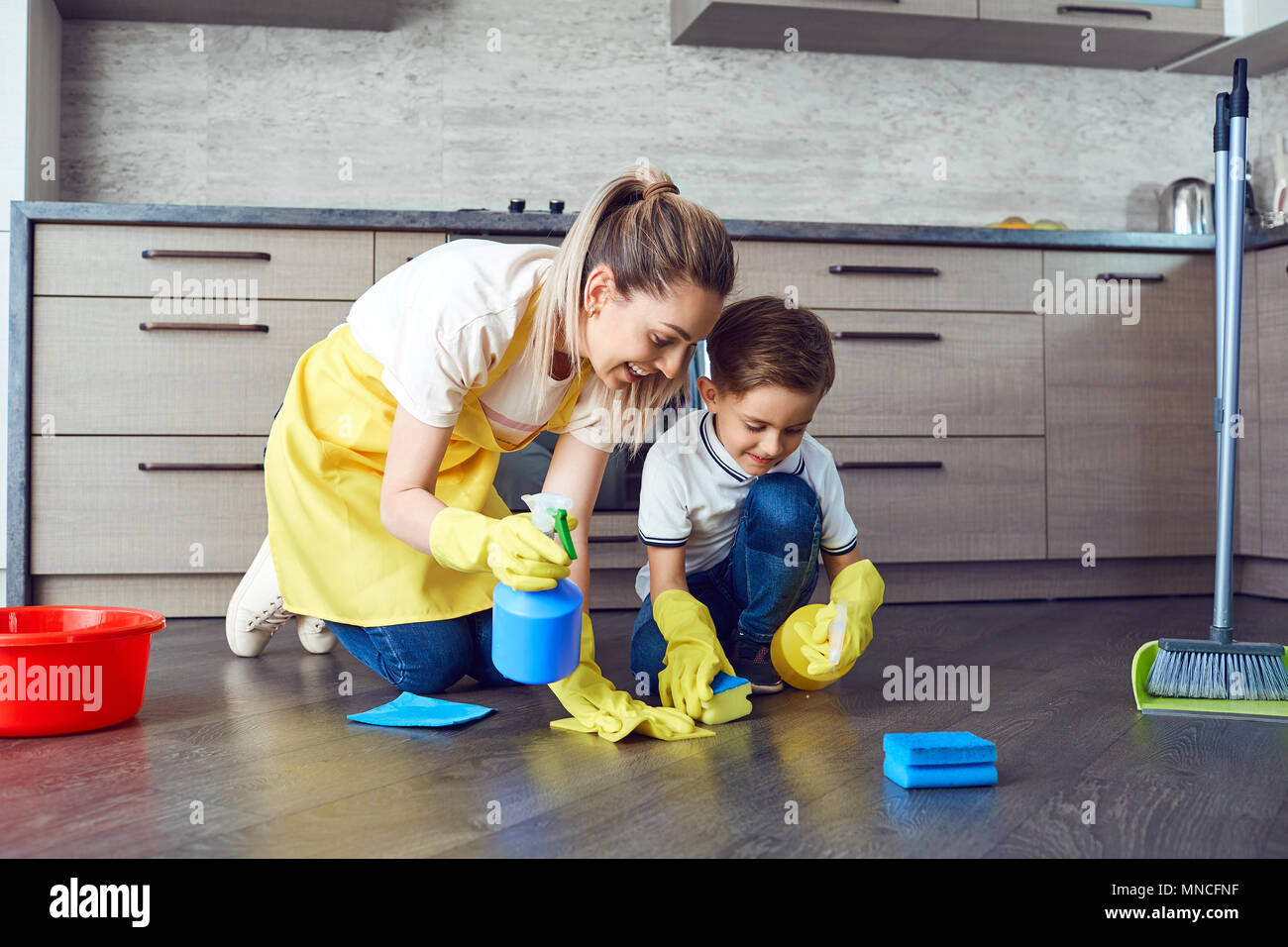 Mother and son are cleaning the apartment. Stock Photo