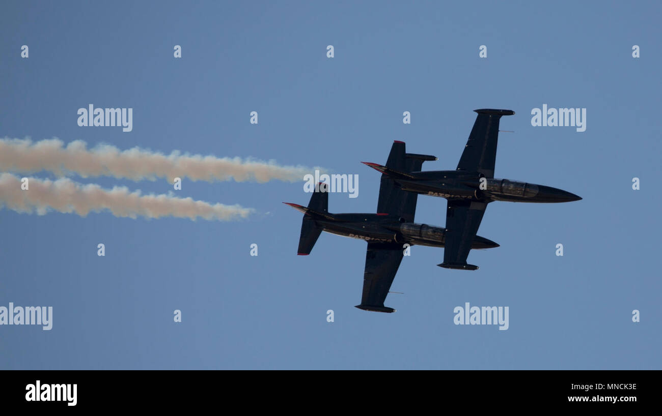 The 2018 Yuma Airshow headliner, The Patriots Jet Team, perform an acrobatic aerial display for spectators during the 2018 Yuma Airshow hosted by Marine Corps Air Station Yuma, Ariz., Saturday, March 17, 2018. The Patriots Jet Team, the largest civilian-owned aerobatic jet team in the western hemisphere, began with the vision of one person: Randy Howell. Fueled by passion for aviation since childhood, it became Howell's mission to create a six-jet precision demonstration team that could entertain, inspire, and educate. The airshow is MCAS Yuma's only military airshow of the year and provides t Stock Photo