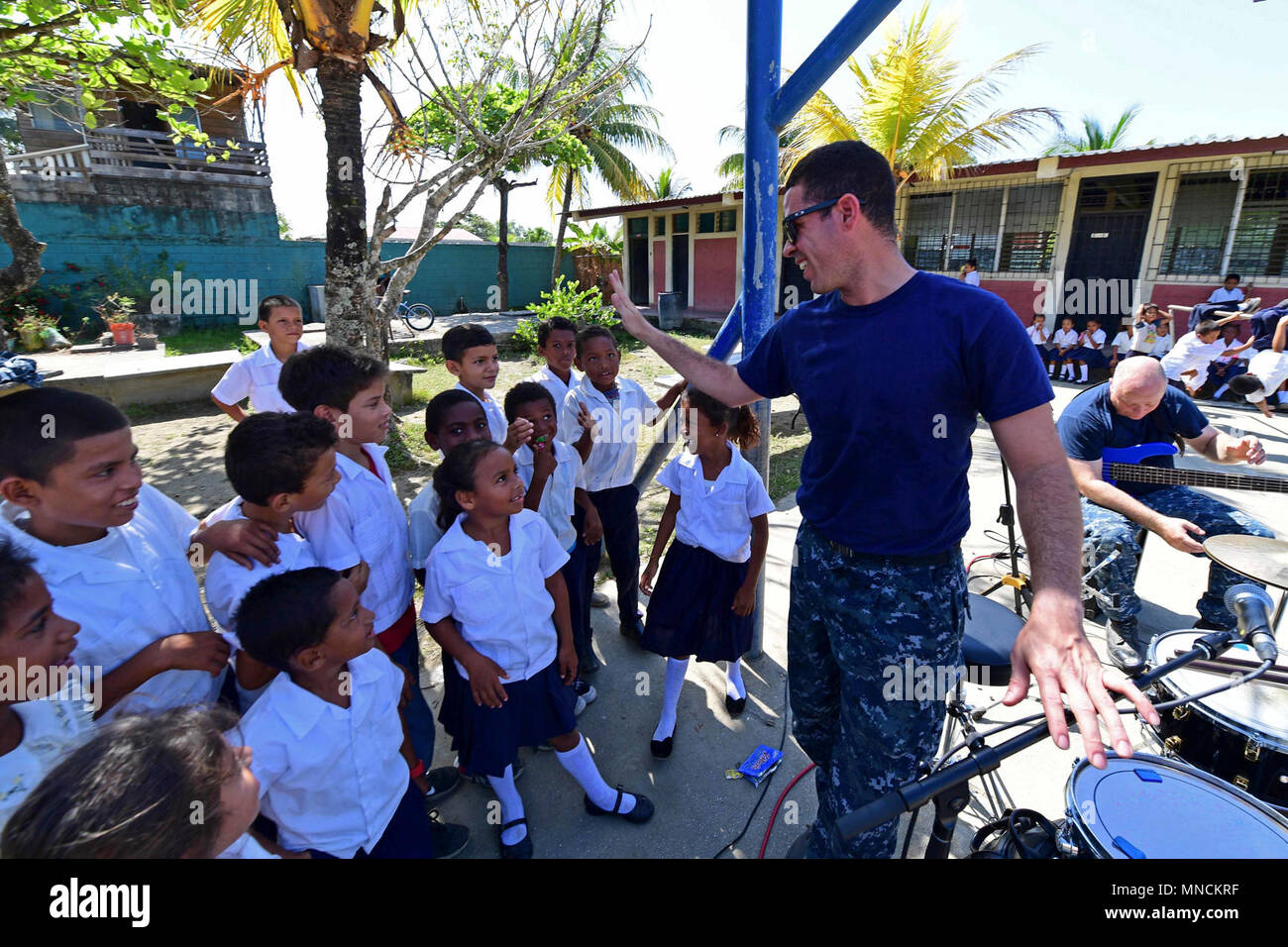 PUERTO CORTES, Honduras (March 18, 2018) Musician 3rd Class Francisco Ortiz, assigned to U.S. Navy Fleet Forces Band, greets children at the School of San Martin during Continuing Promise 2018. U.S. Naval Forces Southern Command/U.S. 4th Fleet has deployed a force to execute Continuing Promise to conduct civil-military operations including humanitarian assistance, training engagements, and medical, dental, and veterinary support in an effort to show U.S. support and commitment to Central and South America. (U.S. Navy Stock Photo