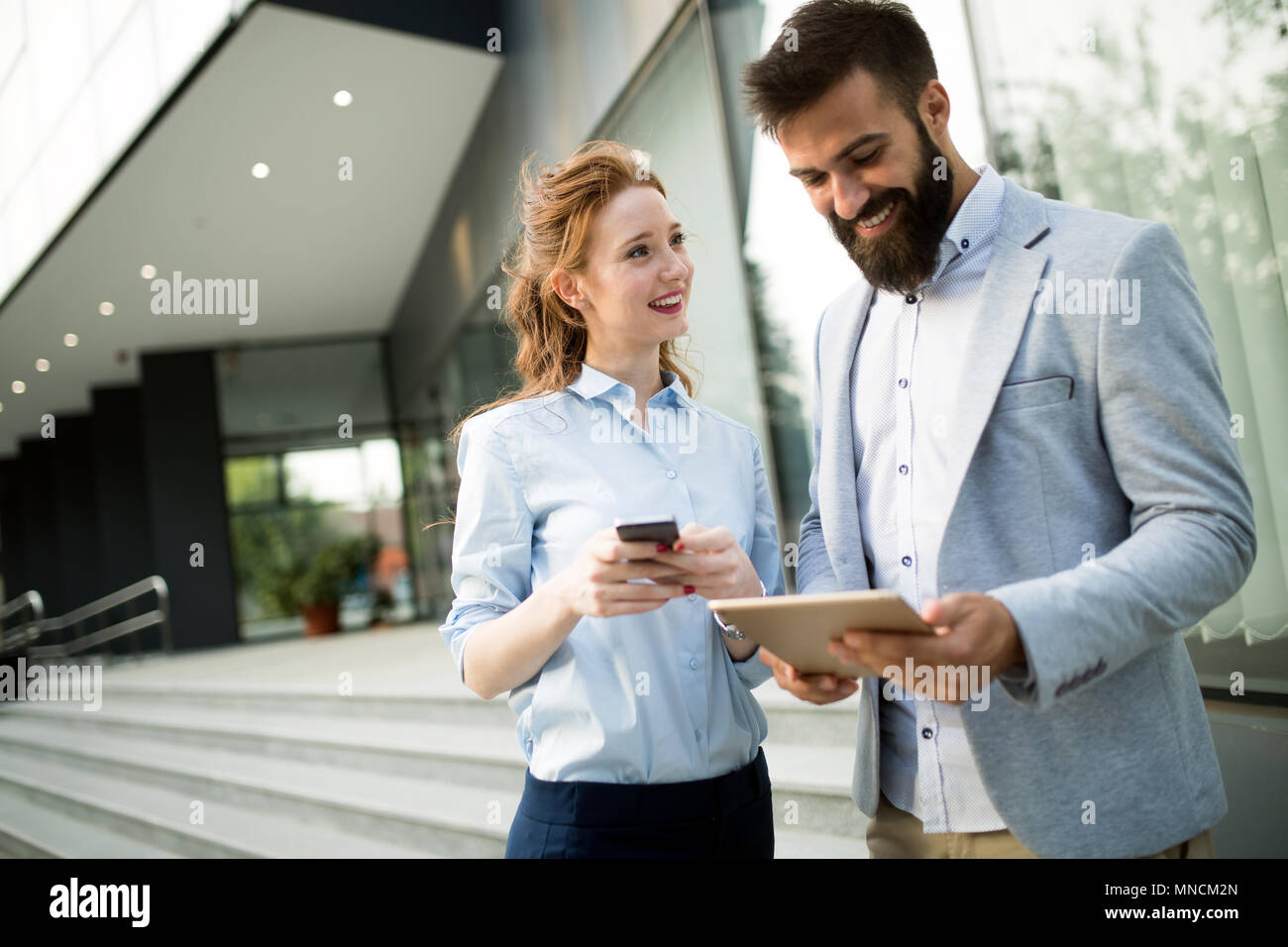 Business people walking and talking outdoor Stock Photo - Alamy