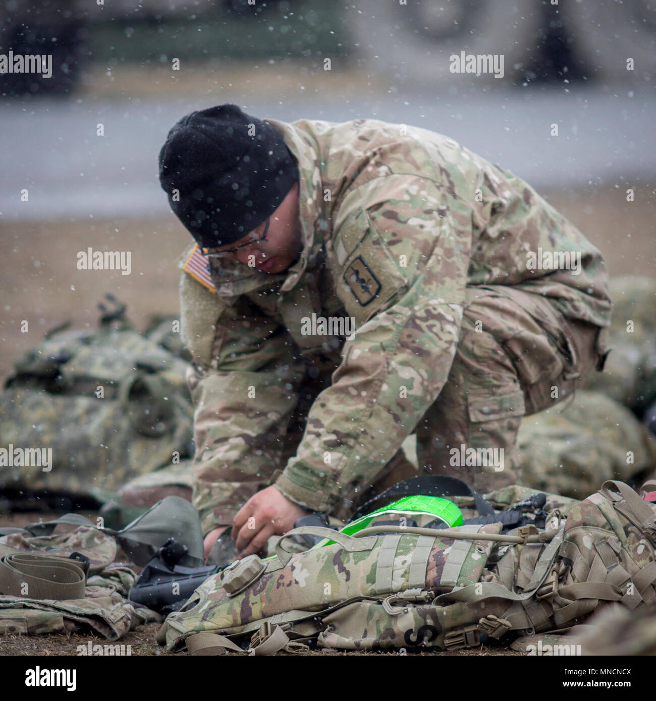 GRAFENWOEHR, Germany – Sgt. Xinyo Gu, operating room technician, 212th Combat Support Hospital, shows his gear during the pre ruck march layout at the 2018 U.S. Army Europe Expert Field Medical Badge March 20, 2018. (U.S. Army Stock Photo