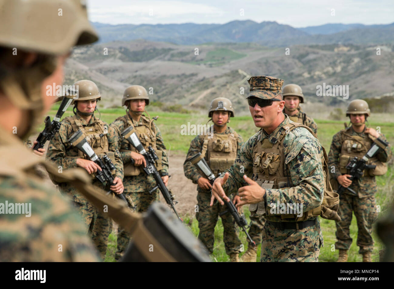 U.S. Marine Staff Sgt. James Boll, a combat instructor with Golf Company, Marine Combat Training Battalion (MCT), School of Infantry – West, instructs Marine on how to conduct patrols on Camp Pendleton, Calif., March 20, 2018. Golf Co. is the first integrated male/female MCT company on the West Coast. (U.S. Marine Corps Stock Photo