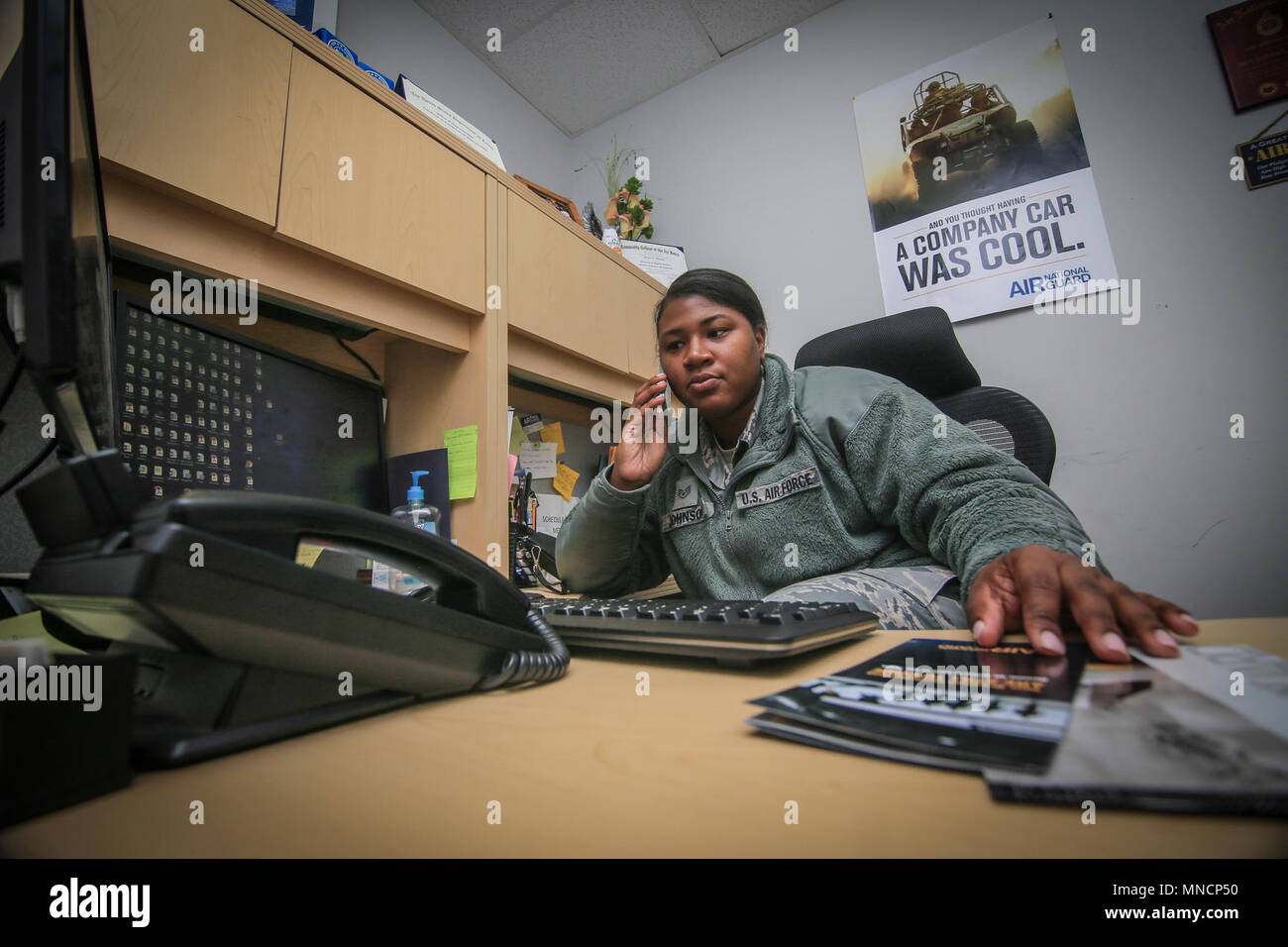 New Jersey Air National Guard Staff Sgt. Jazlyn Johnson, a 108th Wing recruiter, talks on the phone with a potential recruit at Joint Base McGuire-Dix-Lakehurst, N.J., March 20, 2018. Johnson works full time as a corrections officer for East Jersey State Prison. "I work in an all-male prison, so at times it can get difficult," said Johnson. "I tailored my degree to social work so I can understand why people do what they do, and what I can do to help them." (U.S. Air National Guard Stock Photo
