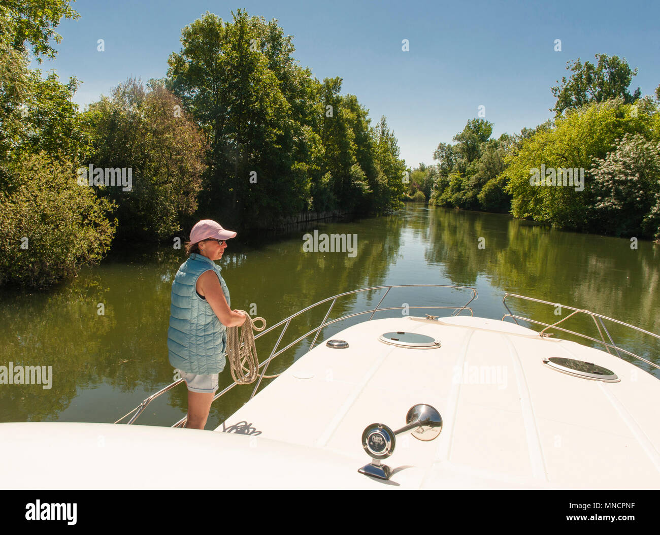 Charente Rier Claudia Albrecht holding ropes while houseboating on the Charente river ...