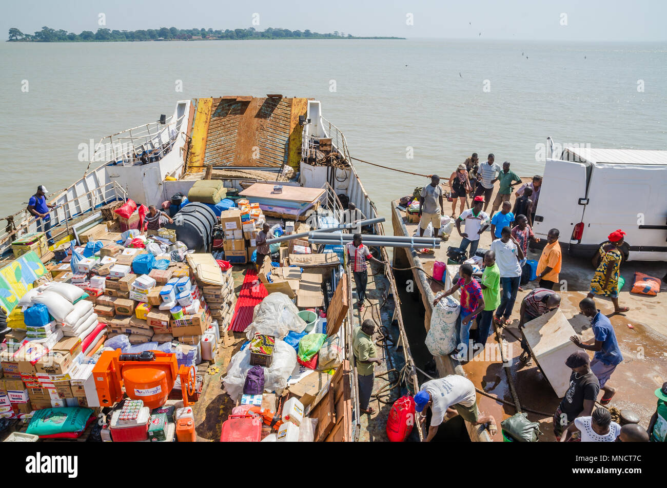 Old ferry being loaded in Bissau harbor, journey to Bubaque, Bijagos Islands Stock Photo