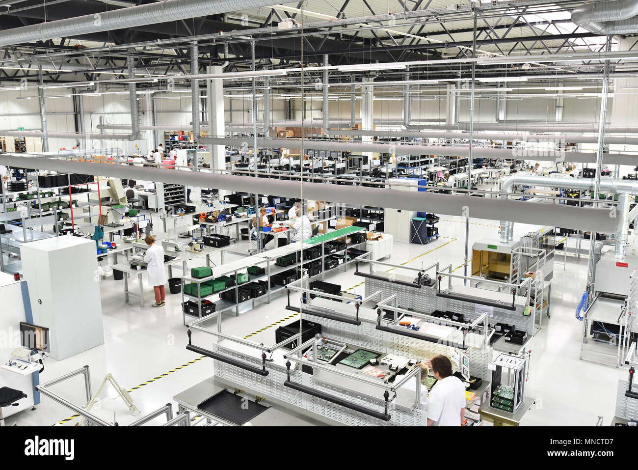 industrial factory for assembly of microelectronics - interior and workers Stock Photo