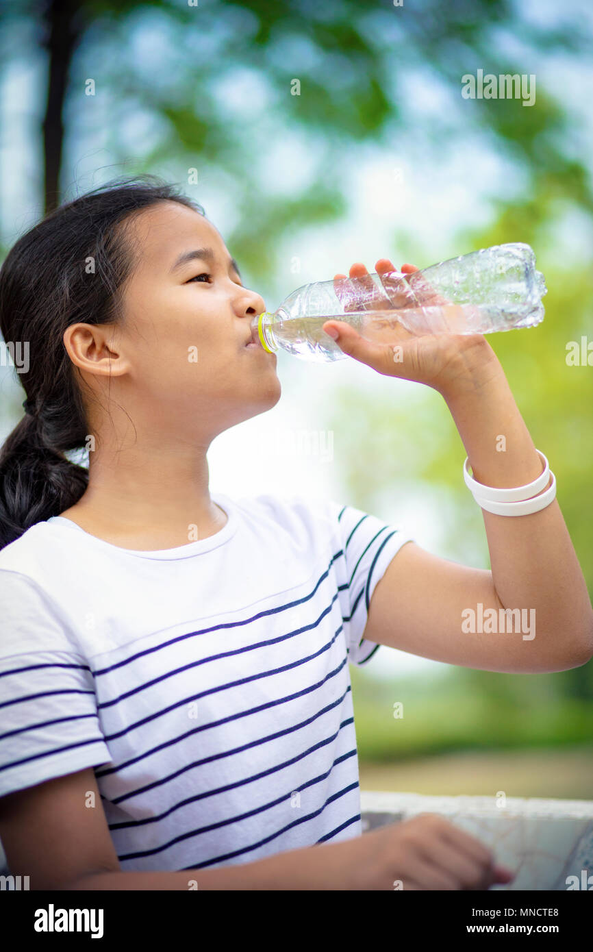 Teenage girl drinks water from bottle Stock Photo by ©BestPhotoStudio  64410247