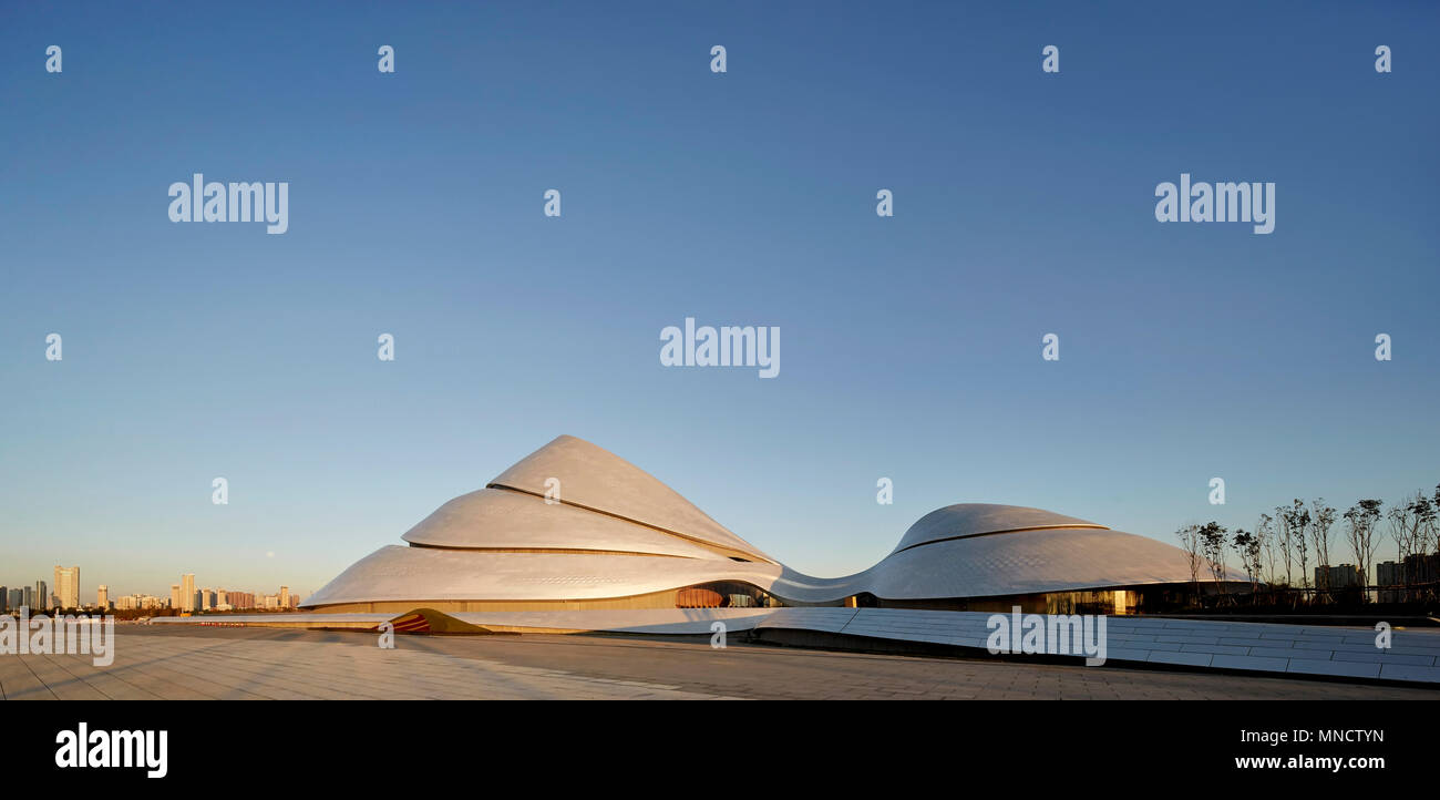 View across public piazza toward building at dawn. Harbin Opera House ...