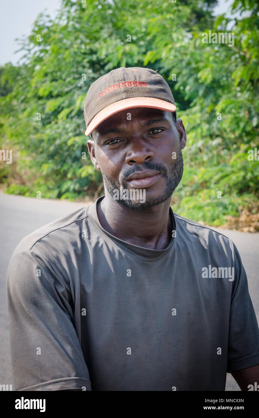 Man, Ivory Coast - January 31,2014: Portrait of unidentified African man with cap looking at camera outdoors Stock Photo