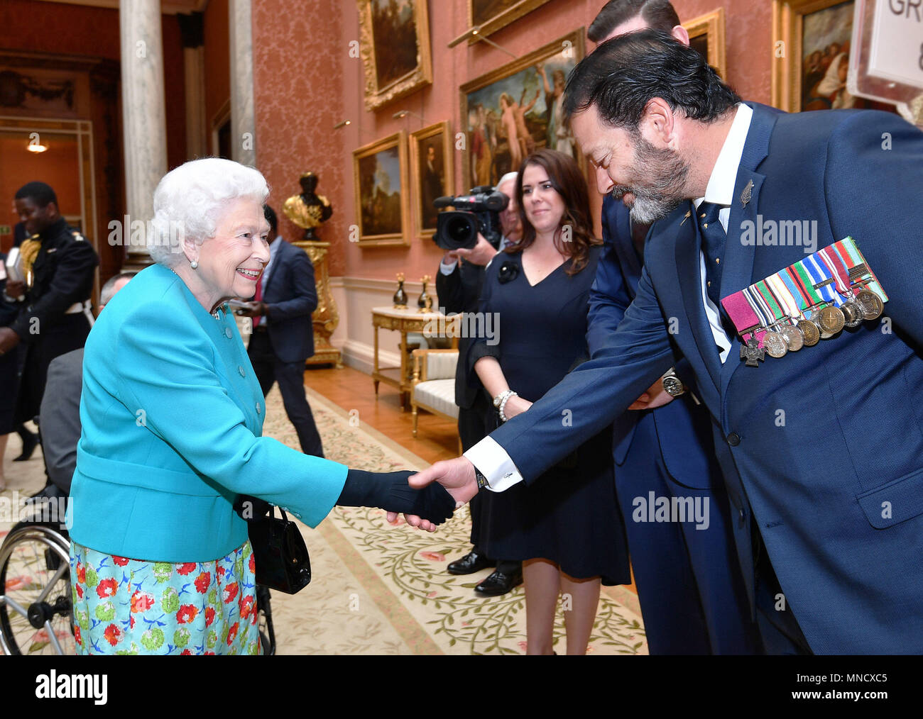 Queen Elizabeth II shakes hands with Mr Willie Apiata VC at a reception