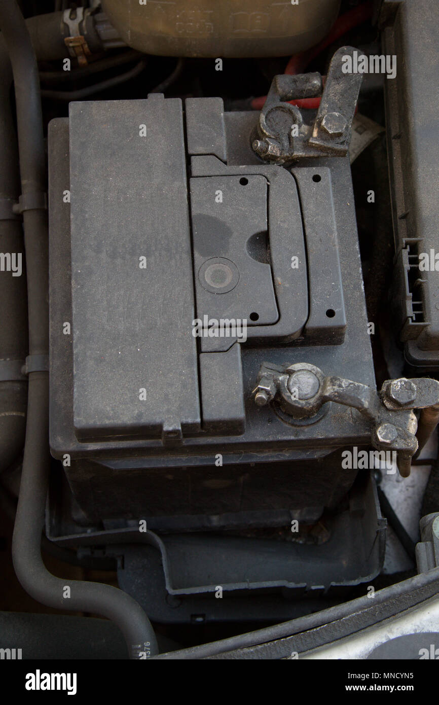 A car battery in place in an engine bay Stock Photo Alamy