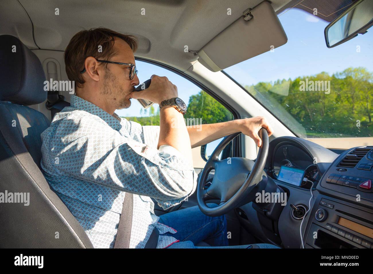 Man holding coffee cup in car Stock Photo - Alamy