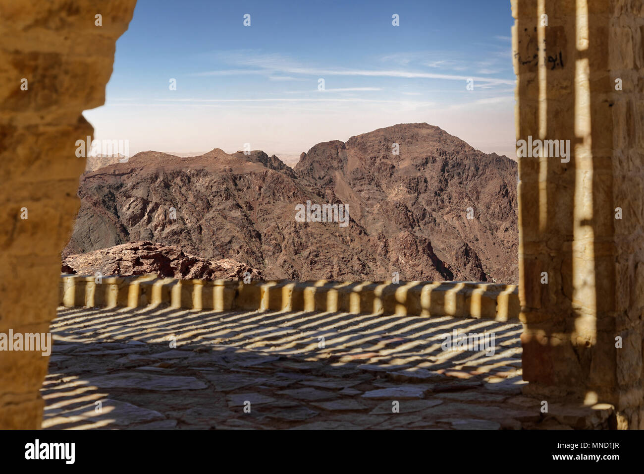 View over a terrace to the barren mountain landscape in southern Jordan, composite photograph Stock Photo