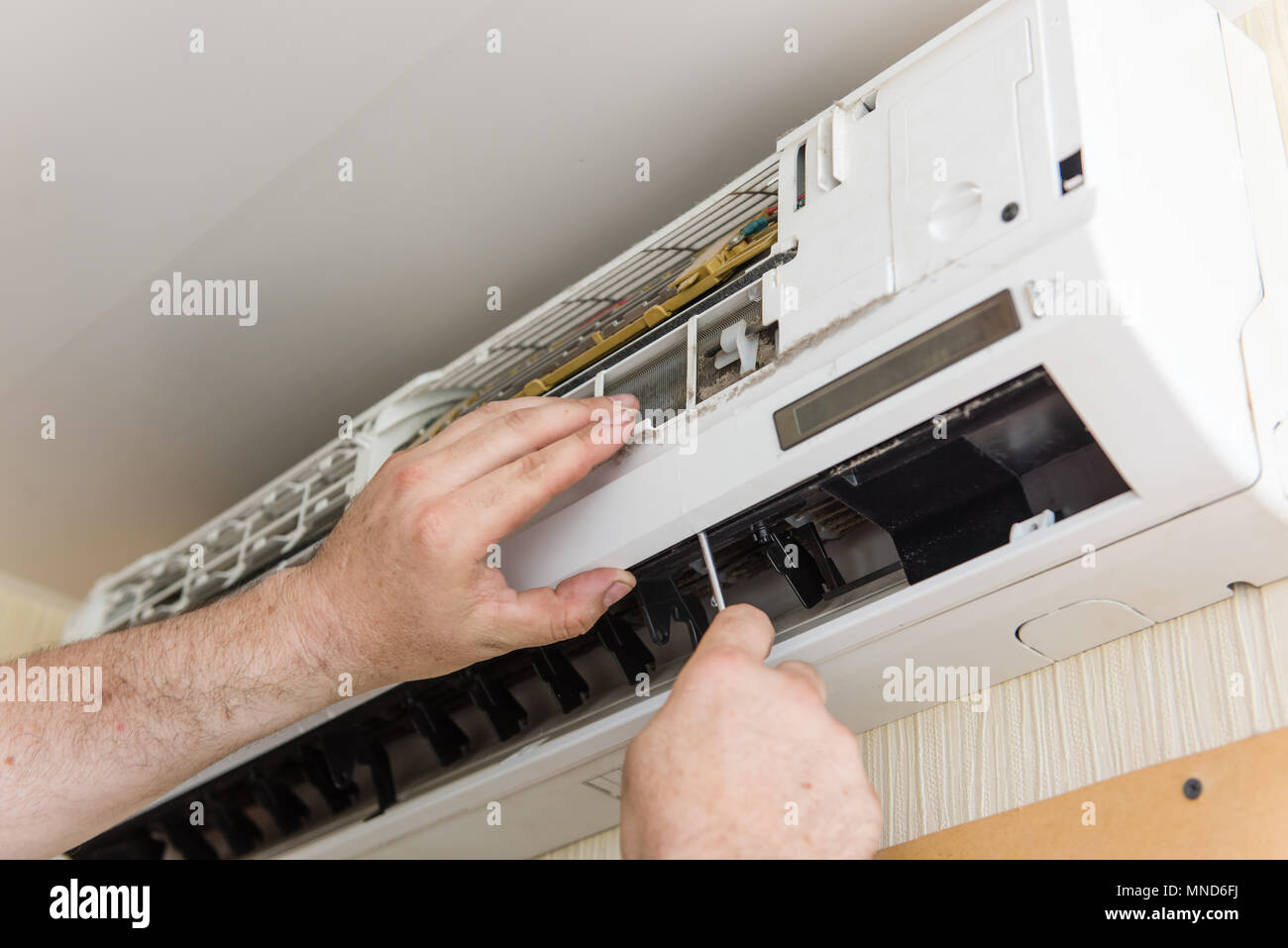 Male hands with instruments make ac condition maintenance Stock Photo