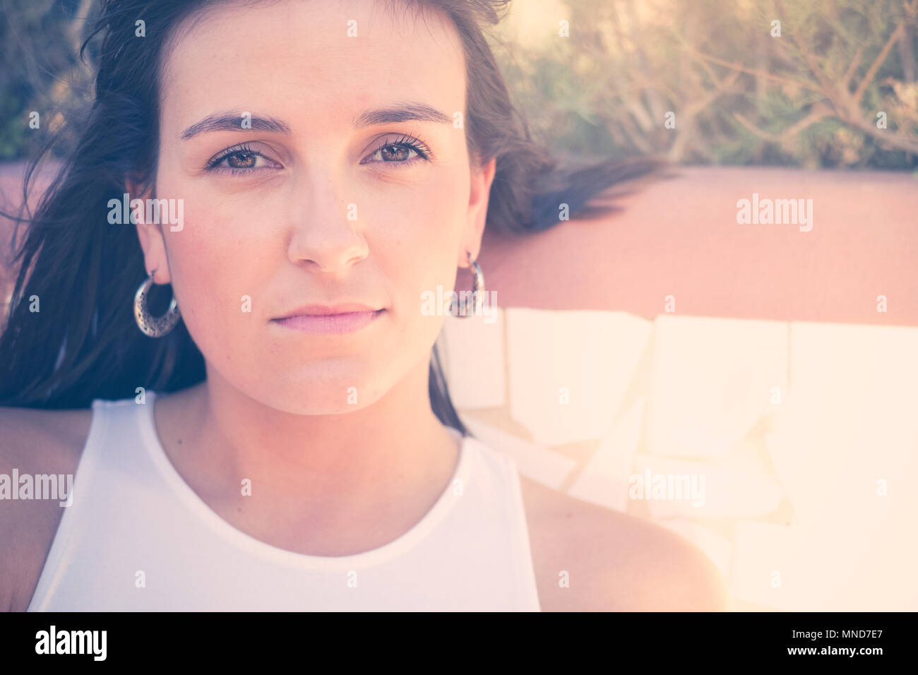 Young nice woman in a close up portrait, long hair and beautiful face. Vintage filter Stock Photo