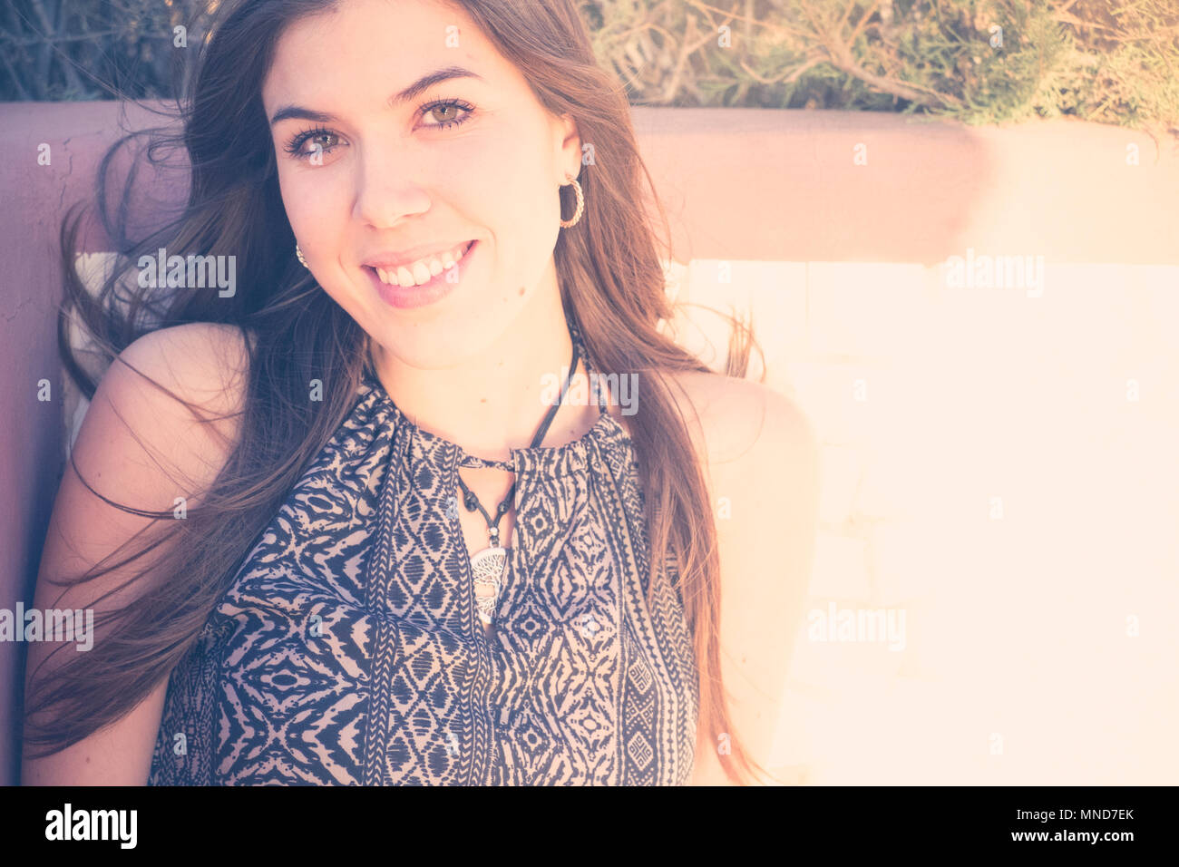 Young nice woman in a close up portrait, long hair and beautiful face. Vintage filter Stock Photo